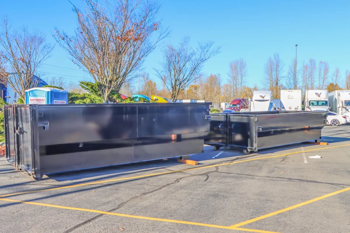 Professional dumpster rental service with roll-off container on residential driveway in North Kansas City